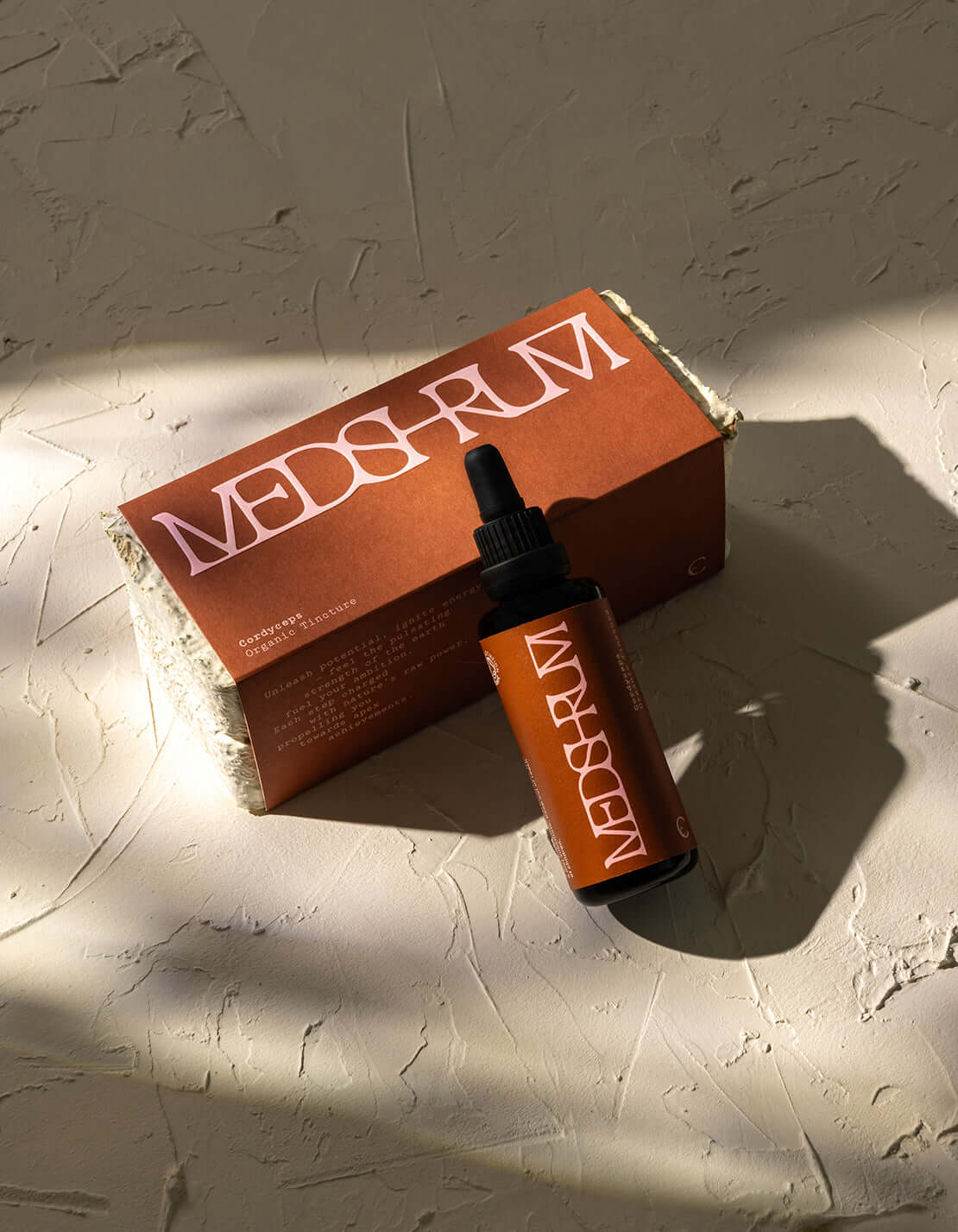 Organic Cordyceps tincture by Medshrum, shown in a glass bottle with a black dropper, on a light background.