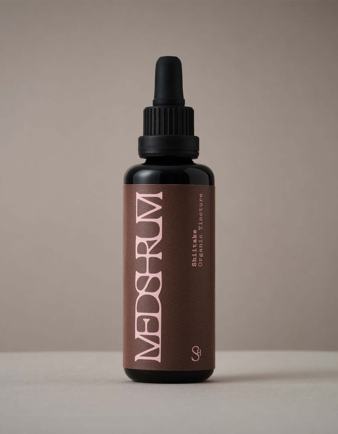 Bottle of Medshrum Shiitake Organic Tincture placed on a neutral background, showcasing the label and eco-friendly mycelium packaging.